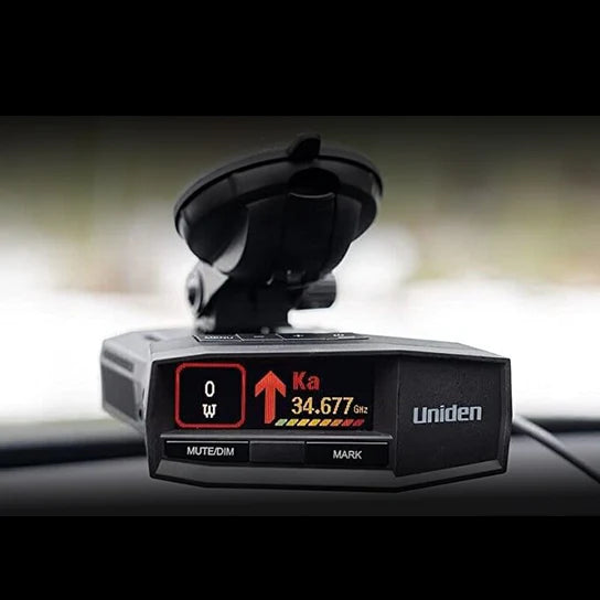 Uniden R8 radar detector top front view with screen on and premium suction cup mounted above dashboard window